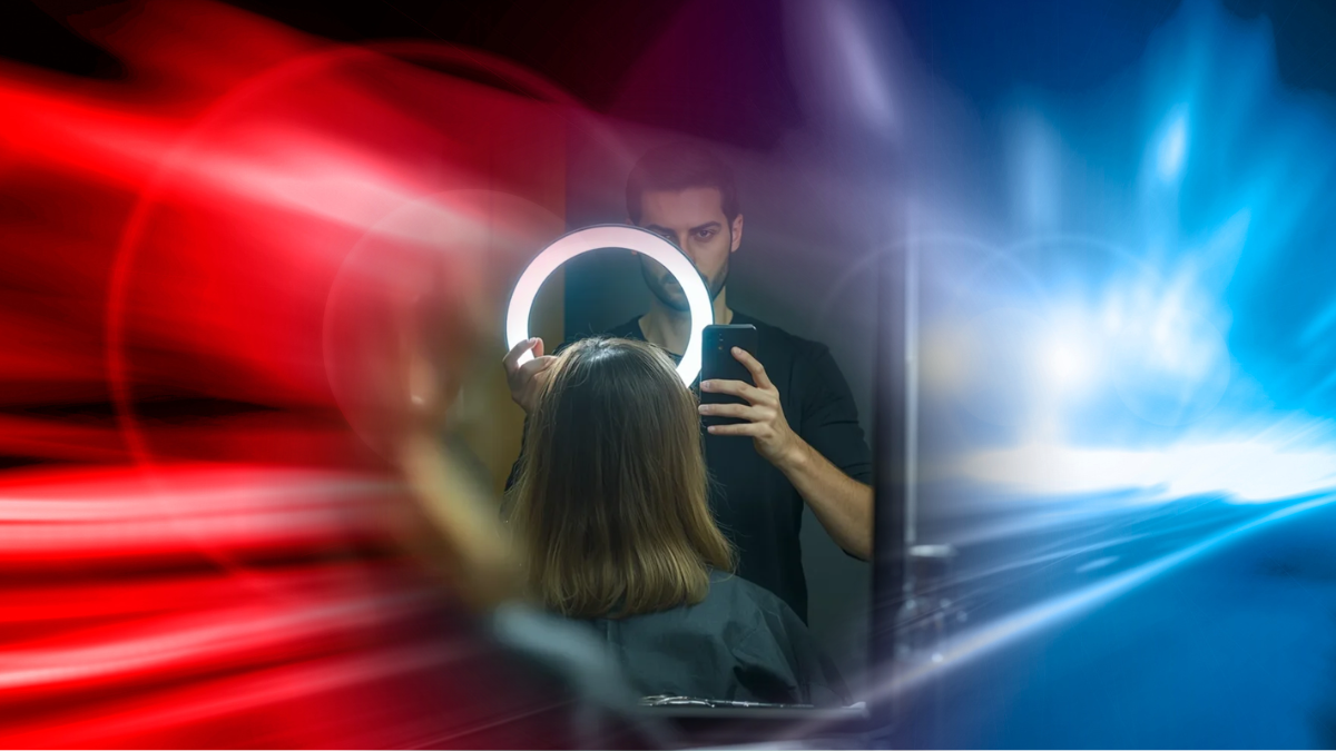 Kritischer Kommentar zur Krise der Friseurbranche: Ein Friseur mit Ringlicht und Smartphone vor einem blau-roten Hintergrund, symbolisch für den Social-Media-Wahn im Salon.